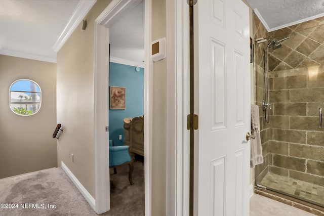 bathroom with ornamental molding and a shower with shower door