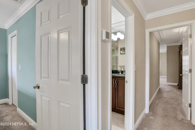 hall featuring light colored carpet and crown molding