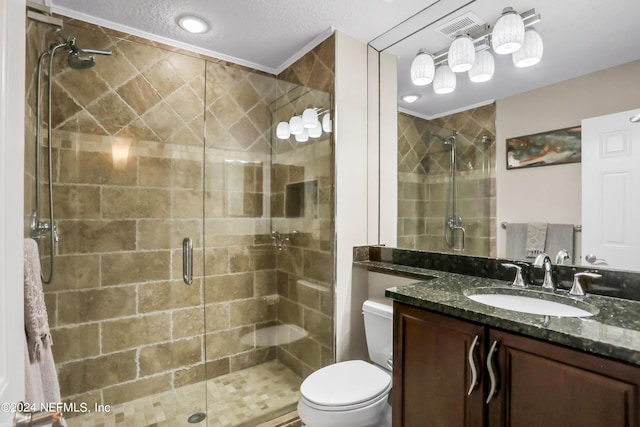 bathroom featuring toilet, an enclosed shower, a textured ceiling, and vanity