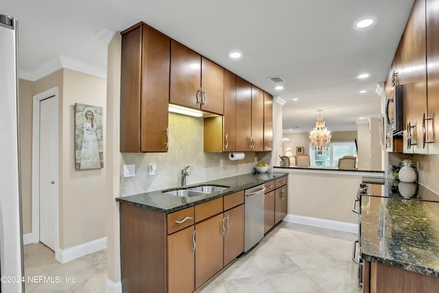 kitchen featuring pendant lighting, sink, stainless steel dishwasher, dark stone countertops, and kitchen peninsula