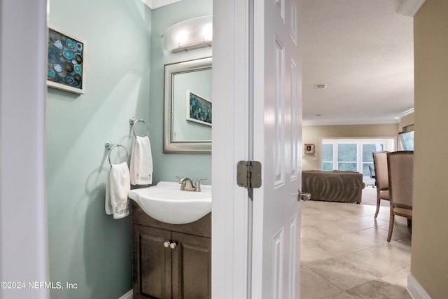 bathroom with vanity and crown molding