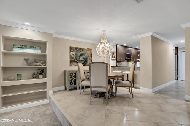 dining room with built in shelves, crown molding, and a notable chandelier