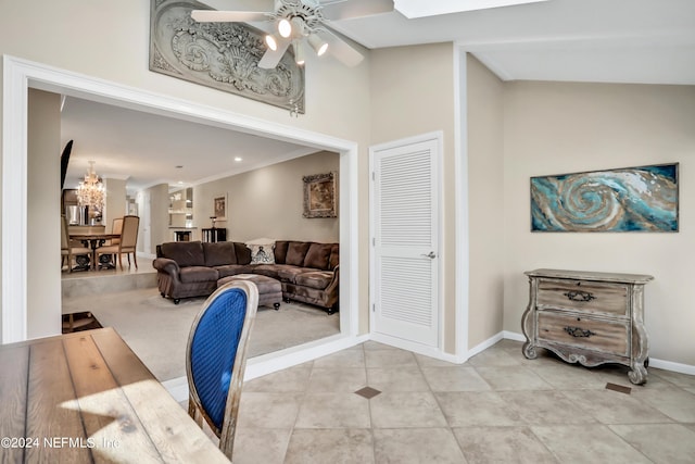 living room with ceiling fan and crown molding