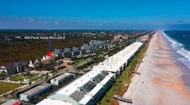 bird's eye view featuring a water view and a beach view