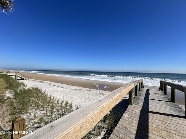 view of home's community featuring a view of the beach and a water view