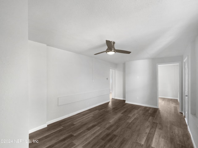 unfurnished room featuring a textured ceiling, ceiling fan, and dark hardwood / wood-style floors