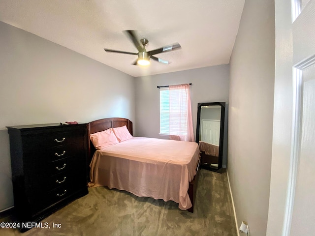 bedroom with dark colored carpet and ceiling fan