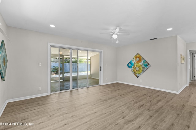 empty room with ceiling fan and light wood-type flooring