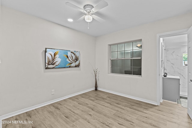 empty room featuring ceiling fan and light wood-type flooring