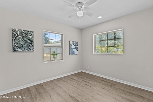 unfurnished room with ceiling fan and light hardwood / wood-style floors