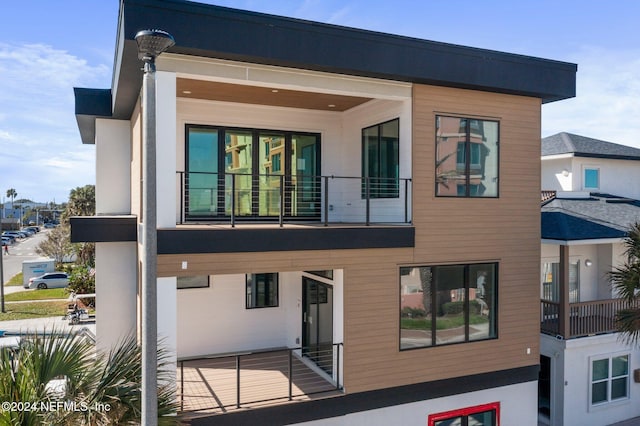 back of property with a balcony