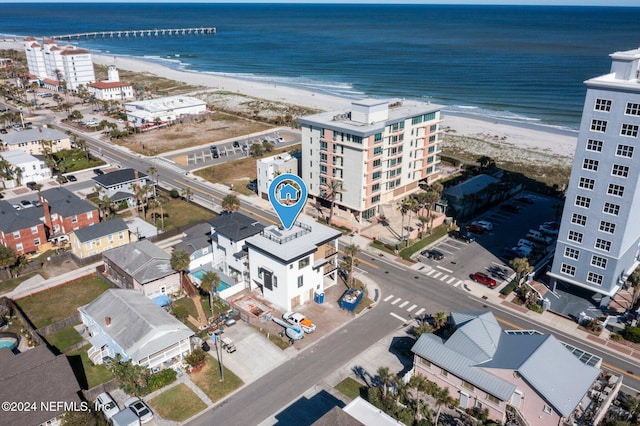 birds eye view of property with a beach view and a water view