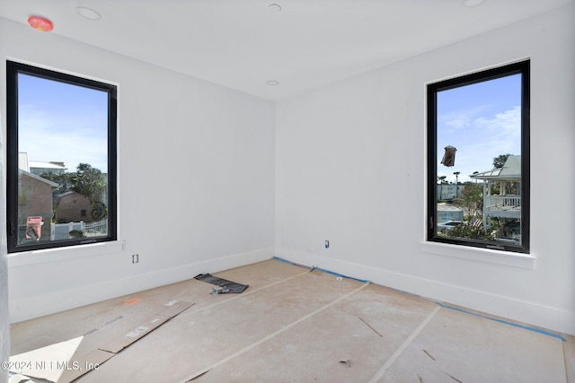 unfurnished room featuring baseboards