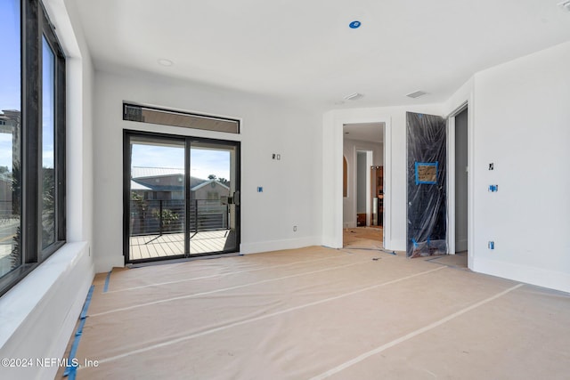 unfurnished room with visible vents and baseboards