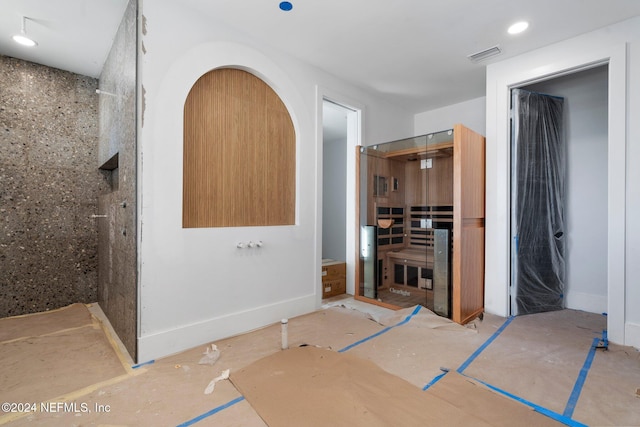 bathroom featuring recessed lighting, visible vents, baseboards, and walk in shower