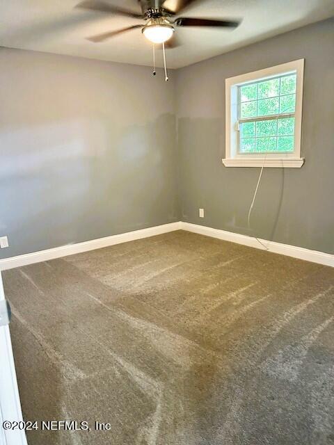 carpeted empty room with ceiling fan