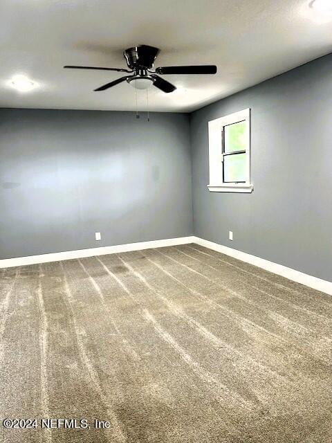 spare room with carpet flooring and ceiling fan