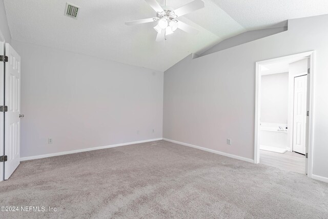 empty room featuring light carpet, ceiling fan, and lofted ceiling