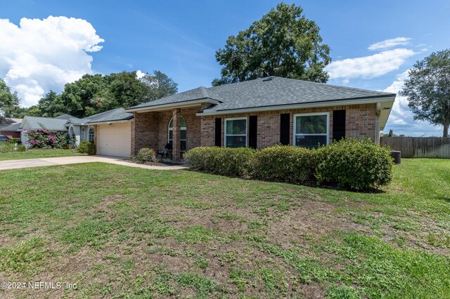 single story home with a garage and a front yard