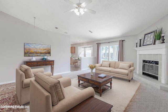 living room with ceiling fan, a fireplace, and light colored carpet