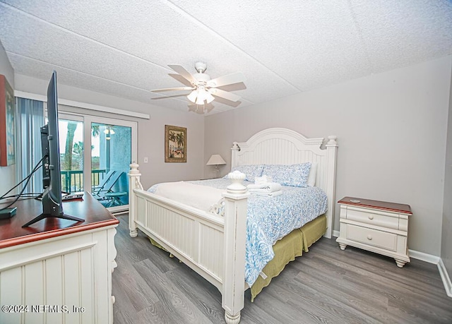 bedroom with access to outside, hardwood / wood-style flooring, a textured ceiling, and ceiling fan