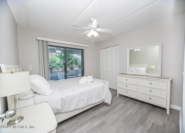 bedroom with access to outside, a textured ceiling, a closet, light wood-type flooring, and ceiling fan