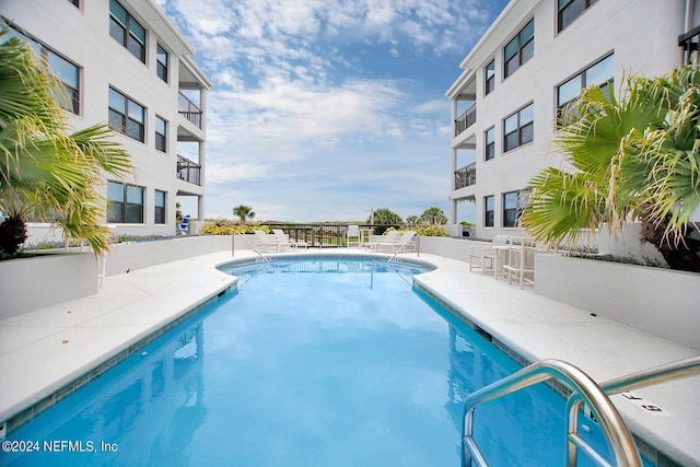 view of swimming pool featuring a patio area