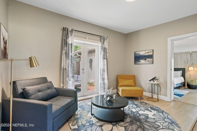 sitting room featuring hardwood / wood-style floors and french doors