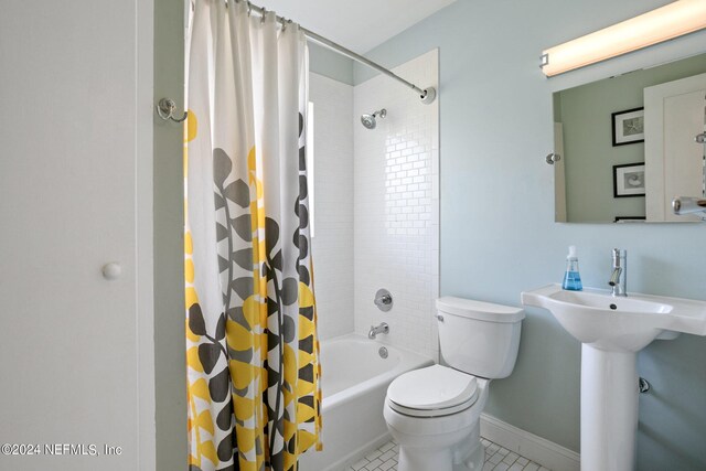 bathroom with shower / bathtub combination with curtain, toilet, and tile floors