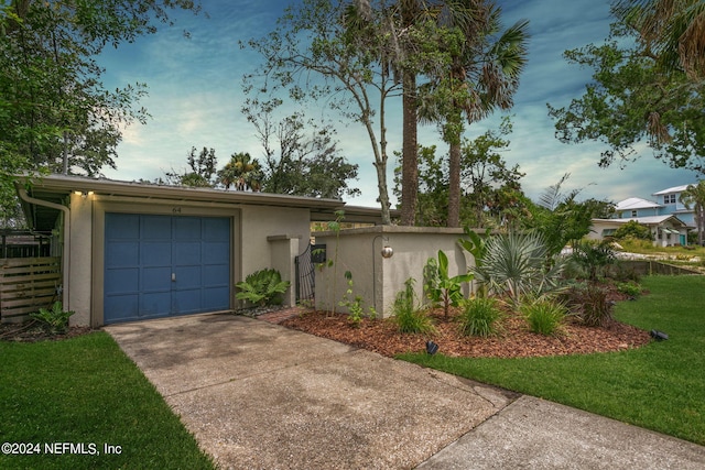 view of front of home featuring a garage and a front lawn