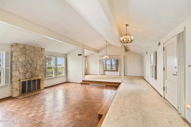 interior space with lofted ceiling with beams, a fireplace, baseboards, and a notable chandelier