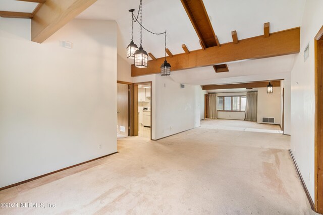 unfurnished living room with beamed ceiling, carpet, visible vents, and baseboards