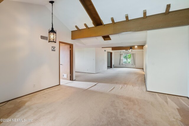 empty room featuring high vaulted ceiling, visible vents, beamed ceiling, and carpet flooring