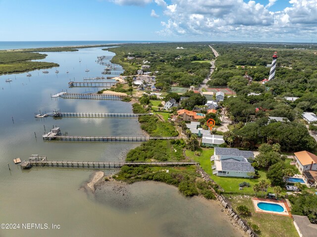 drone / aerial view with a pier and a water view