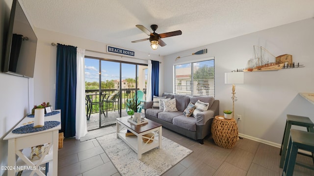 living room featuring a textured ceiling and ceiling fan