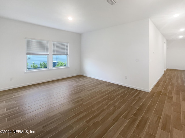 spare room featuring dark hardwood / wood-style flooring