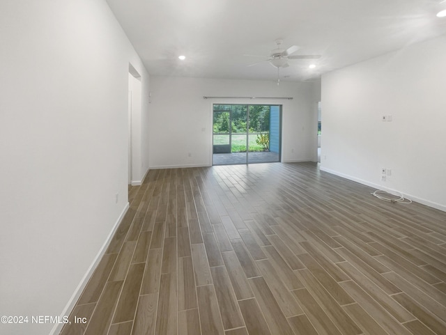 spare room featuring ceiling fan and dark hardwood / wood-style flooring