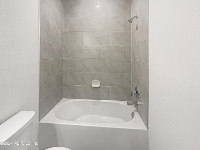 bathroom with shower / washtub combination and toilet