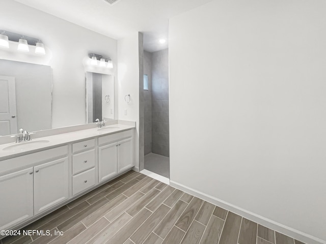 bathroom featuring vanity and tiled shower