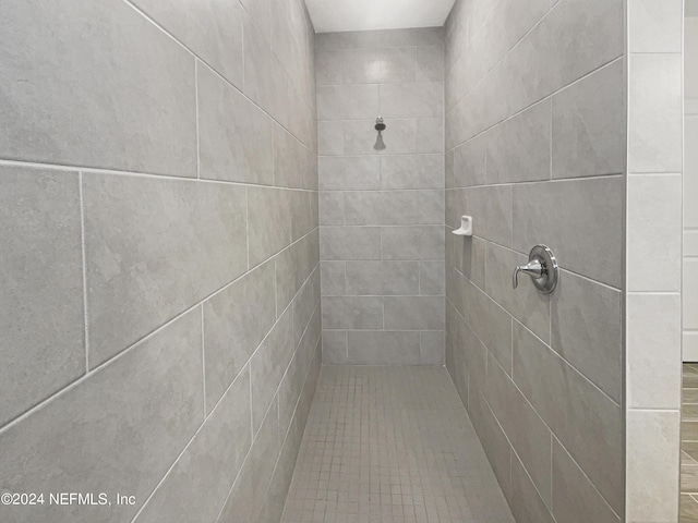 bathroom with tiled shower