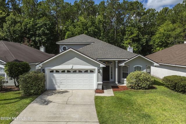 view of front of house with a front yard and a garage