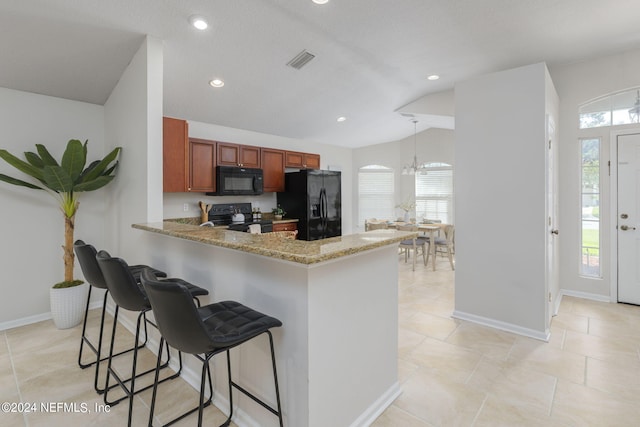 kitchen with kitchen peninsula, black appliances, pendant lighting, a chandelier, and lofted ceiling