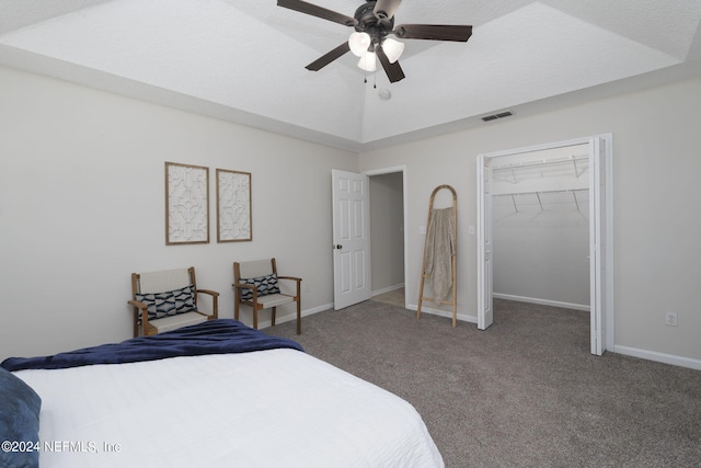 bedroom with carpet, vaulted ceiling, ceiling fan, a spacious closet, and a closet