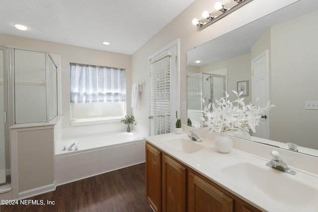 bathroom with independent shower and bath, vanity, and wood-type flooring