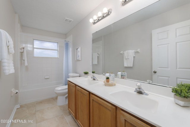 full bathroom with vanity, tile patterned flooring, toilet, shower / bath combo with shower curtain, and a textured ceiling