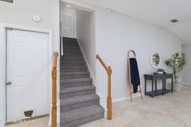 stairs with lofted ceiling