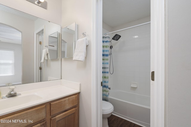 full bathroom with hardwood / wood-style floors, vanity, toilet, and shower / bathtub combination with curtain