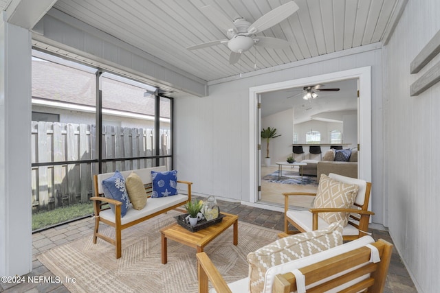 sunroom with plenty of natural light, ceiling fan, and vaulted ceiling