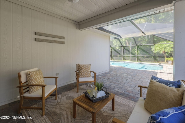 view of patio with glass enclosure and an outdoor living space