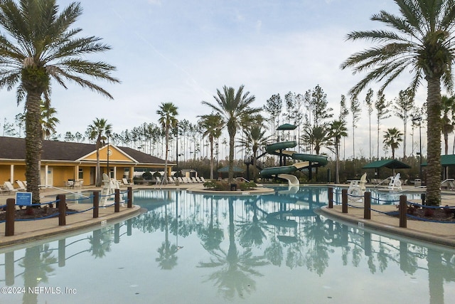 view of pool with a patio and a water slide